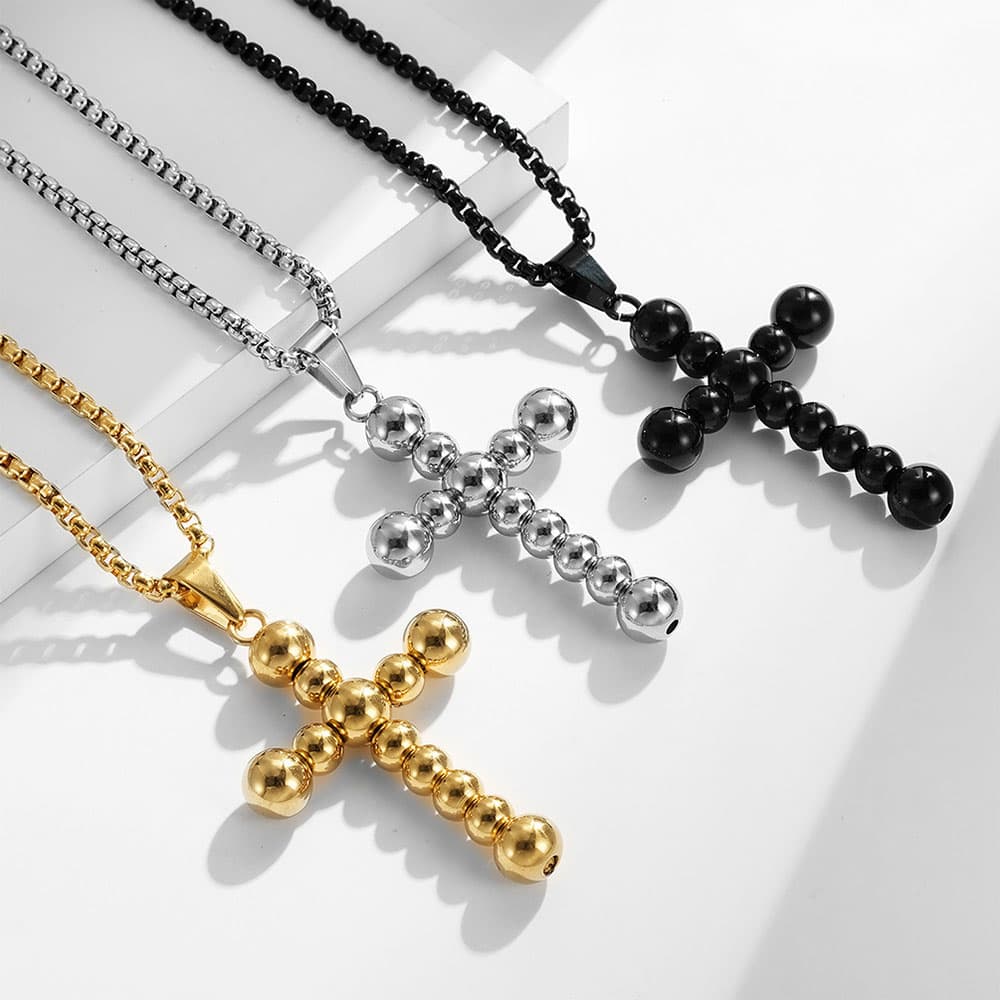 Three color variations of stainless steel beaded cross necklaces in gold, silver, and matte black, wholesale minimalist religious pendant jewelry.