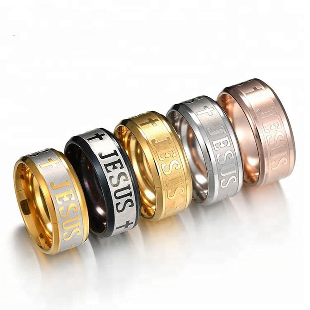 A collection of five 8mm stainless steel Christian rings featuring engraved Jesus text and cross symbols in gold, rose gold, silver, black, and two-tone finishes on a white background.