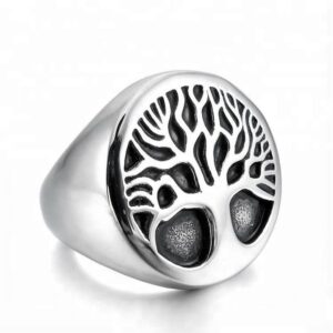 Men's vintage stainless steel Tree of Life signet ring with an oval face and oxidized black detailed Celtic roots and branches on a white backdrop.