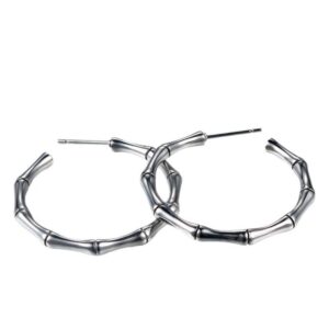 Pair of silver stainless steel bamboo hoop earrings featuring an embossed bamboo joint texture, retro chunky fashion statement jewelry for women.
