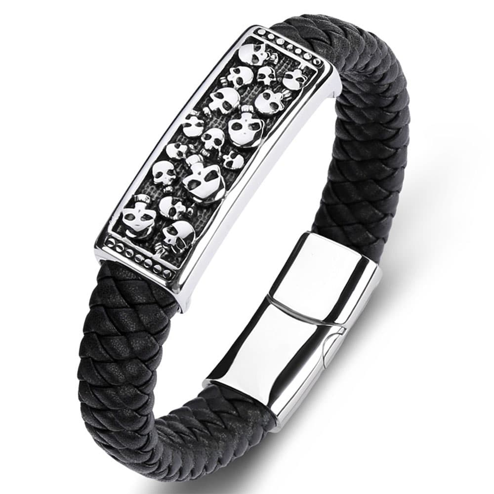 Personalized black braided genuine leather bracelet with a detailed stainless steel multi-skull ID plate and a polished magnetic clasp.