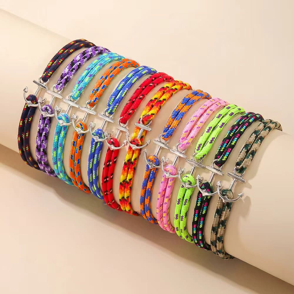 A colorful array of adjustable nautical rope anchor bracelets showcasing vibrant neon, multi-tone, and classic cord colors with silver anchor charms.