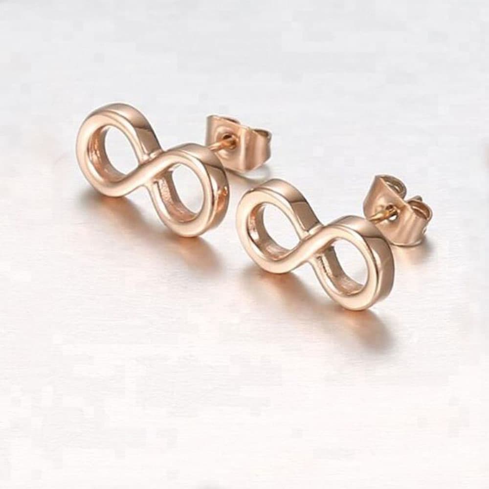 Pair of dainty minimalist infinity stud earrings in a warm rose gold-plated stainless steel finish with butterfly friction backs.