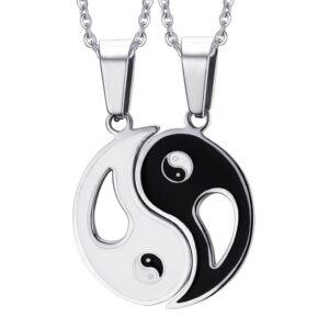 Two matching silver-tone stainless steel Yin Yang puzzle pendant necklaces for couples, one side in white enamel and the other in black enamel.