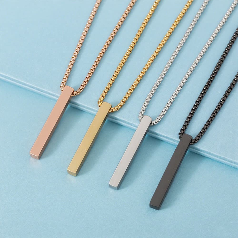 Custom engravable stainless steel vertical bar pendants in rose gold gold silver and black with matching box chains.