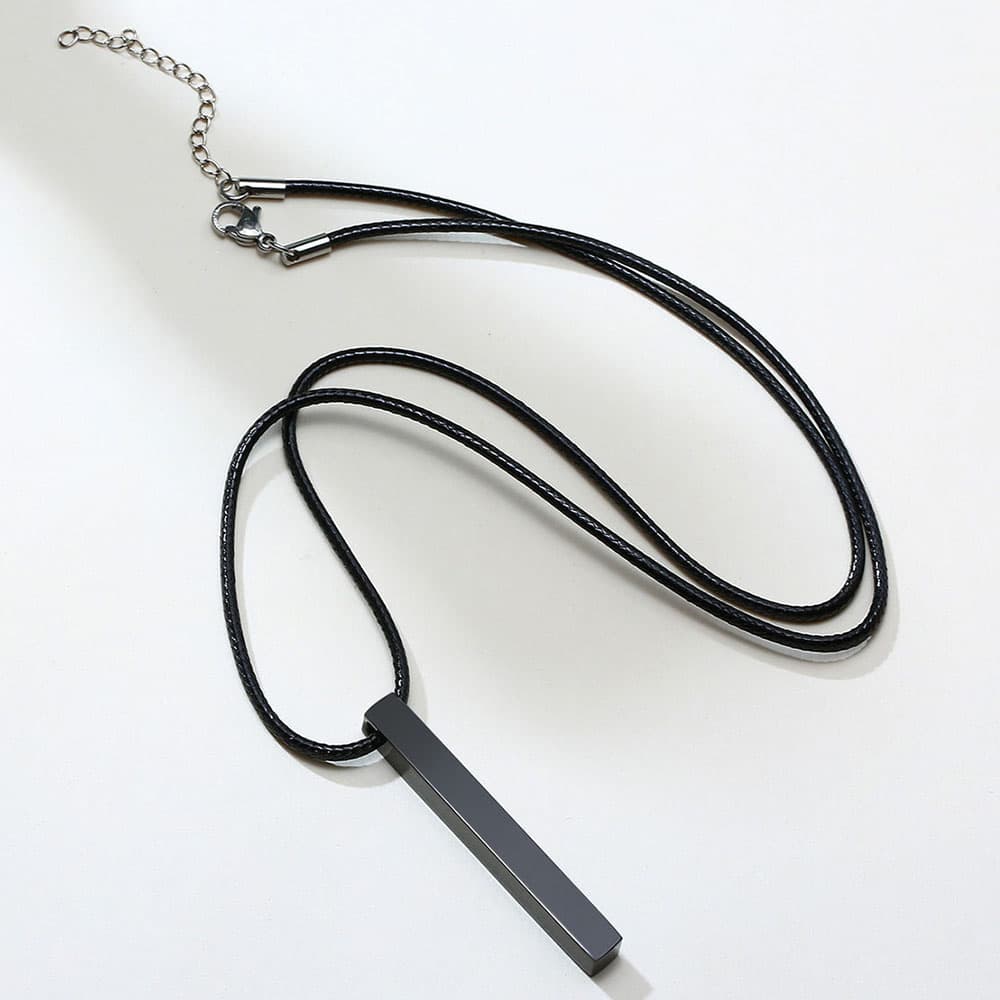 Matte black stainless steel square pillar bar pendant necklace with adjustable chain clasp and extension loop on white background.