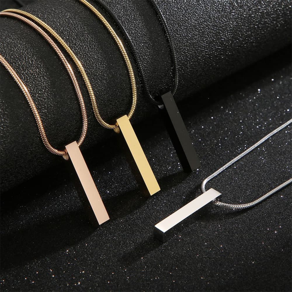 Four color stainless steel engravable 3D bar pendants in silver gold rose gold and black on matching metallic snake chains.
